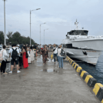 Passengers boarding a fast boat at Gili Trawangan Harbor before departing to Bali, one of the best boat in Bali travel experiences.