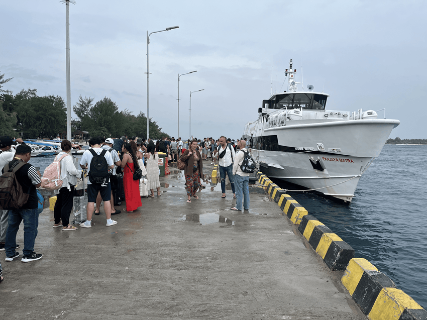 Passengers boarding a fast boat at Gili Trawangan Harbor before departing to Bali, one of the best boat in Bali travel experiences.