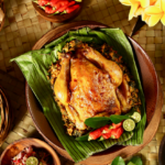 Traditional Balinese Ayam Betutu served with local side dishes, one of the best food in Bali experiences for travelers.